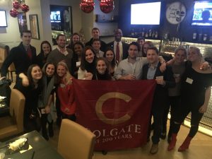 Group picture of young alumni in a Chicago bar holding a Colgate at 200 Years banner