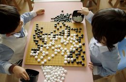 Two children play Go