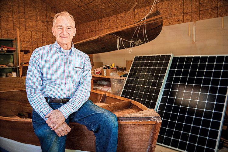 David Borton sitting with Solar panels