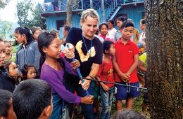 Coffman teaches Laotian children how to use a tree borer to sample Asian swamp cypress.