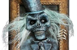 spooky ghoul in top hat bursting out of picture frame