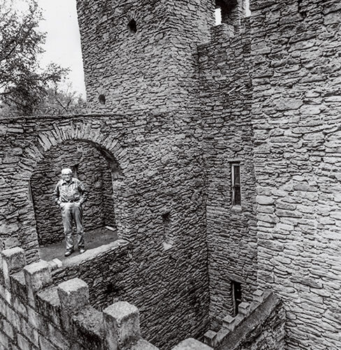 Harry Andrews poses in the castle he built in Loveland.
