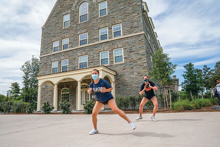 students exercising outside of building on campus