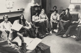 a black and white photo of coed classroom