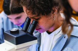 Student looks into microscope