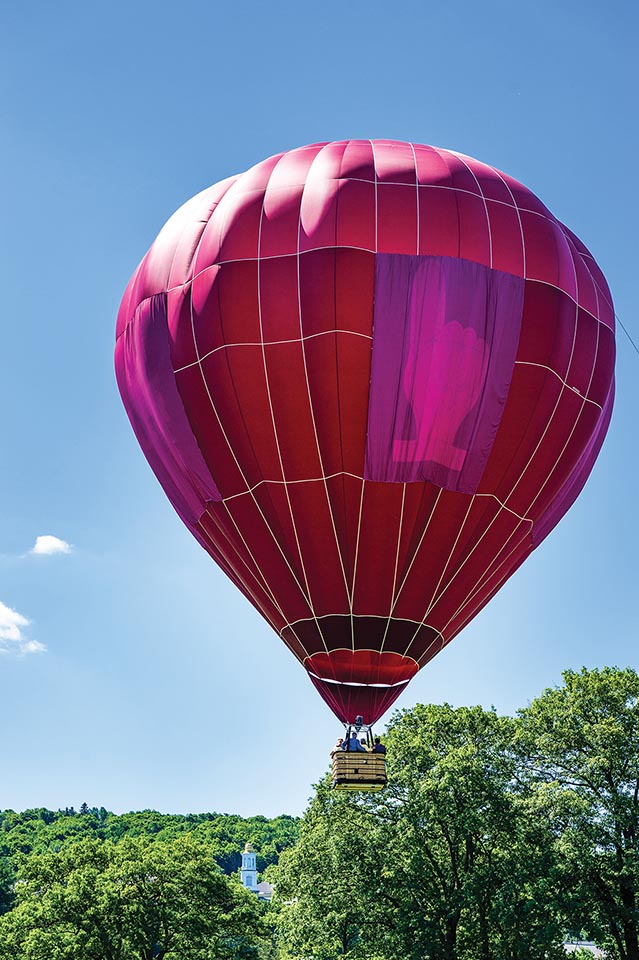 A hot air balloon hovers over campus during Reunion
