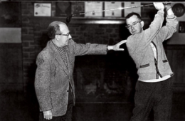 Donald C. Allen, who was captain of the Colgate golf team, demonstrates his swing with instruction from Coach Dalgety.
