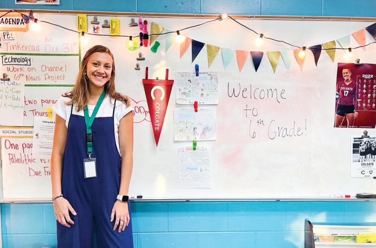 Julia Kurowski stands in front of a classroom whiteboard