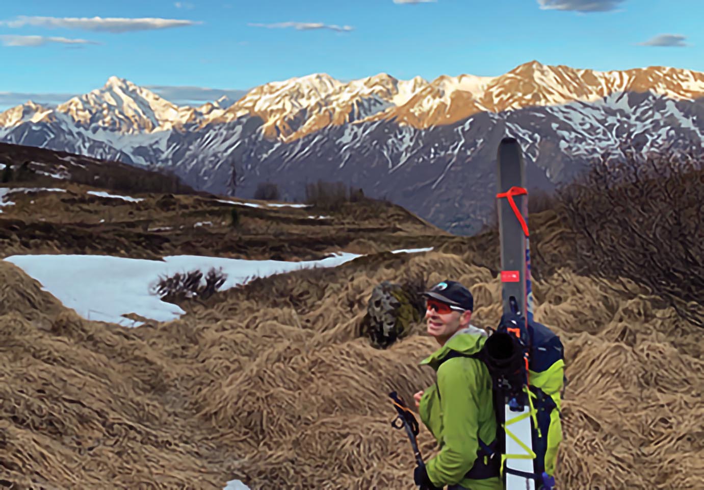 Colgate alumnus Gary Kuehn '85 stands in the open with mountains in the background as he prepares for his next adventure.
