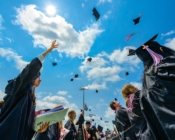 Graduating seniors throw their caps in the air