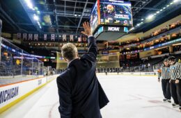 Hockey coach Don Vaughan waving to arena