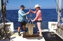 Colgate student and Dauphin Island employee deploy a box corer to sample the seafloor.