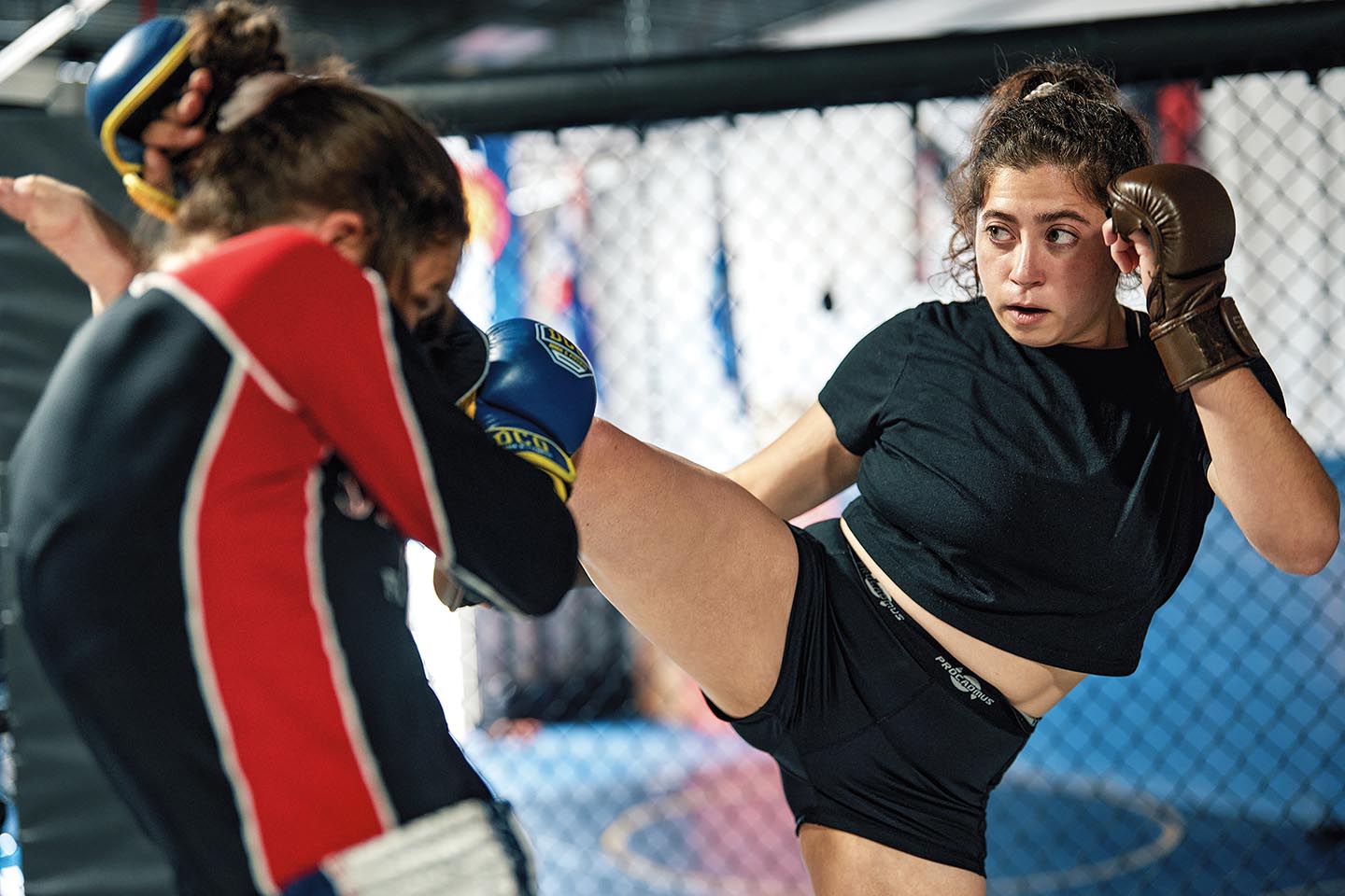 Kassandra Alberico ’17 kicks opponent during mixed martial art practice
