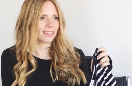 Katie Bedwell '02 Riordan holds a black and white striped piece from her clothing line