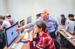 Jeff Barry works with a student in the computer lab