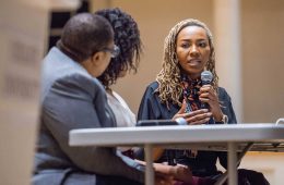 Opal Tometi speaking with a microphone on Chapel Stage
