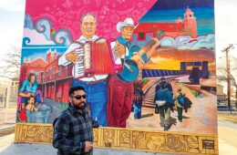 Muralist Cimi Alvarado in front of an El Paso Mural he created