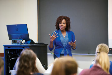 Ynesse Abdul-Malak teaching in a classroom