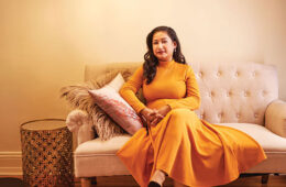 Fatima Anwar on a tufted couch