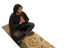 Adrielle Jefferson sitting cross-legged on a yoga mat
