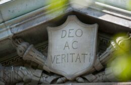 Detail on campus building: "Deo ac Veritati" on a shield