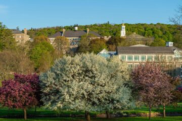 Scenic view of upper campus from below Payne Creek, flowering crabtrees in foreground