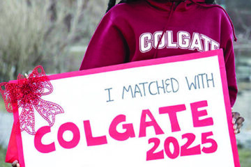 Student holding a Questbridge Scholar sign "I Matched With Colgate 2025"