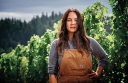 Portrait of Kate Norris standing in a vineyard