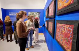 Museum visitors view hand-stitched molas