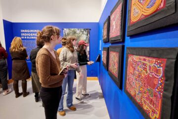 Museum visitors view hand-stitched molas