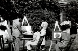 Black and white image of Black artists painting at easels outdoors