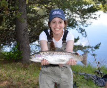 Arielle Sperling holds up a live fish