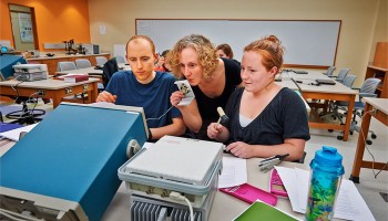 Professor Beth Parks works with students in a frequencies lab
