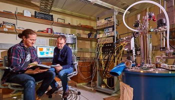 Segall and his student Matt LeGro ’15 sit near helium condensing equipment