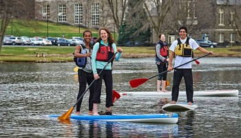 Students stand-up paddle boarding on Taylor Lake