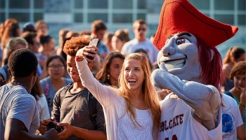 Student snaps a selfie with Raider.