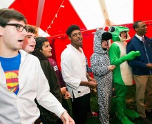 The Colgate Thirteen sing a capella in costumes at a Halloween tailgate