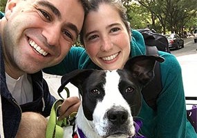 Jess Blank and Adam Weisbarth with a foster dog
