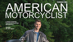 Ben Rich '99 standing by his electric motorcycle on the cover of American Motorcyclist