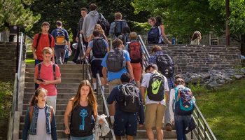 Students walk to class up and down the Persson stairs