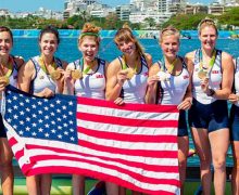 Lauren Schmetterling ’10, fourth from left, standing with gold medal with her rowing teammates