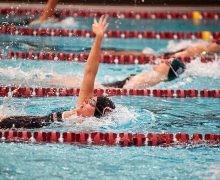 Female swimmers in the pool, mid-race