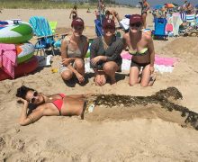 It’s no tall tail: (L to R) Meghan Fogarty ’13, Amanda Harris ’13, Maddie Bell ’13, and mermaid Jo Belluardo ’13 won first place in a sandcastle competition in Rhode Island last summer.
