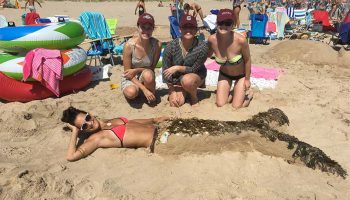 It’s no tall tail: (L to R) Meghan Fogarty ’13, Amanda Harris ’13, Maddie Bell ’13, and mermaid Jo Belluardo ’13 won first place in a sandcastle competition in Rhode Island last summer.