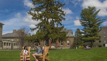 Students lounge in two of the Quad’s 13 new Adirondack chairs.