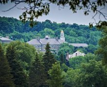 The Colgate University campus, as seen amidst lush foliage from the Seven Oaks Golf Course.