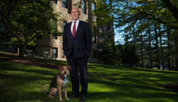President Casey outside James B. Colgate Hall with his dog, Emrys.