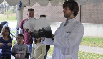 Brendan Mullan '07 does a science demonstration for an audience