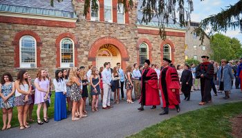President Brian W. Casey and Provost Tracey Hucks '87, MA'90 lead a procession of faculty on the Academic Quad amidst first-year students before convocation