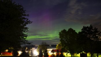 The lights of the Aurora Borealis as seen over the lights of campus